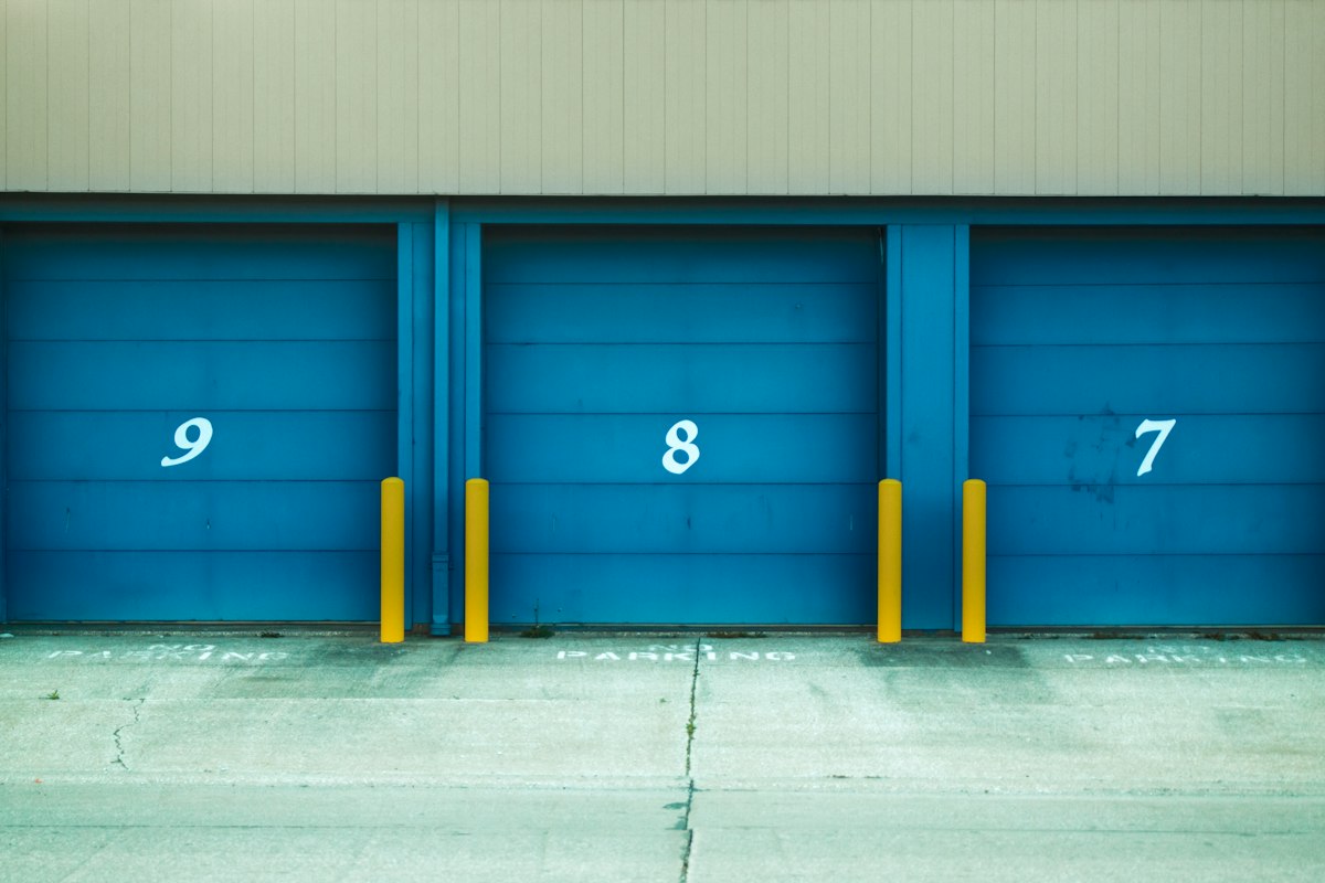 Row of metal roller doors along a commercial unit