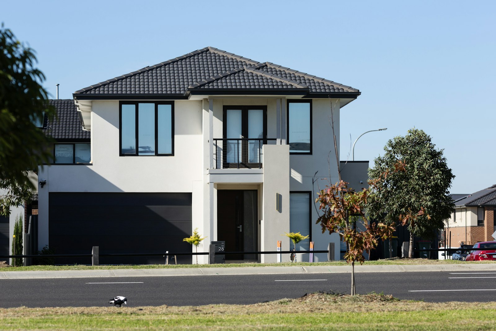 Two-story house with a dark paneled garage door