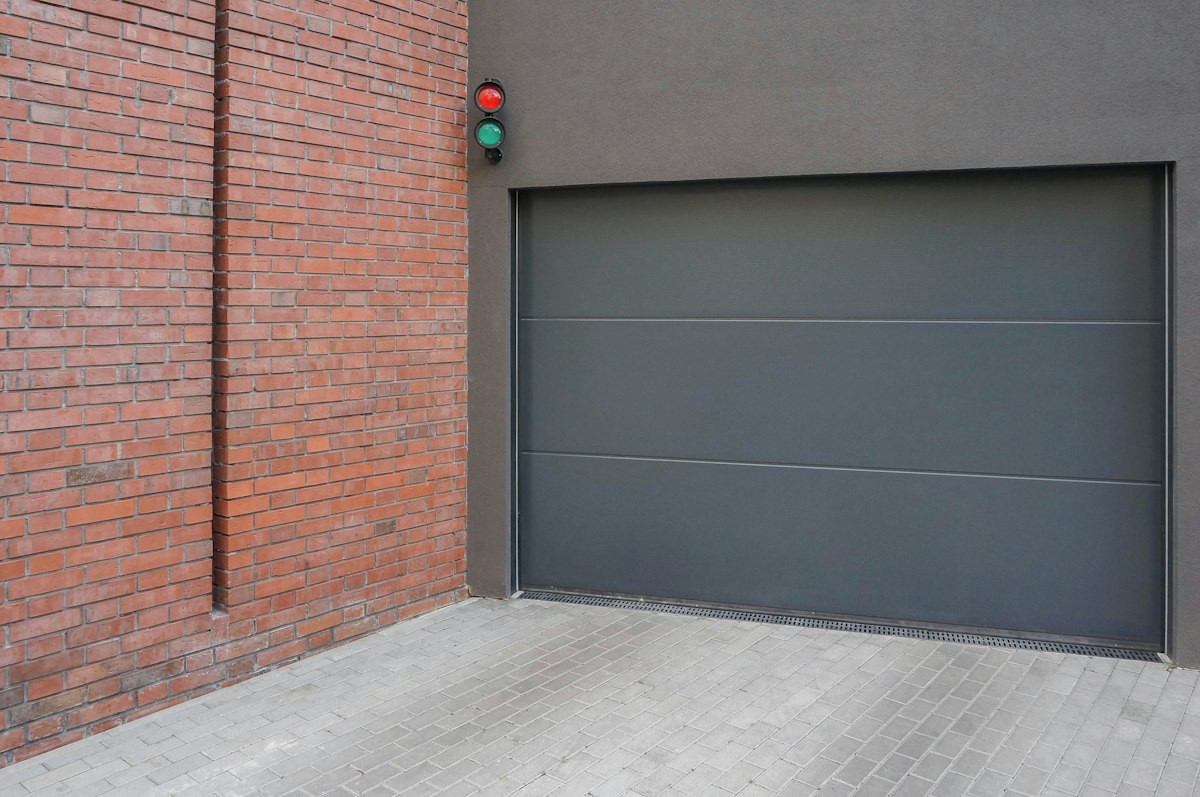 Gray sectional garage door beside a painted wall