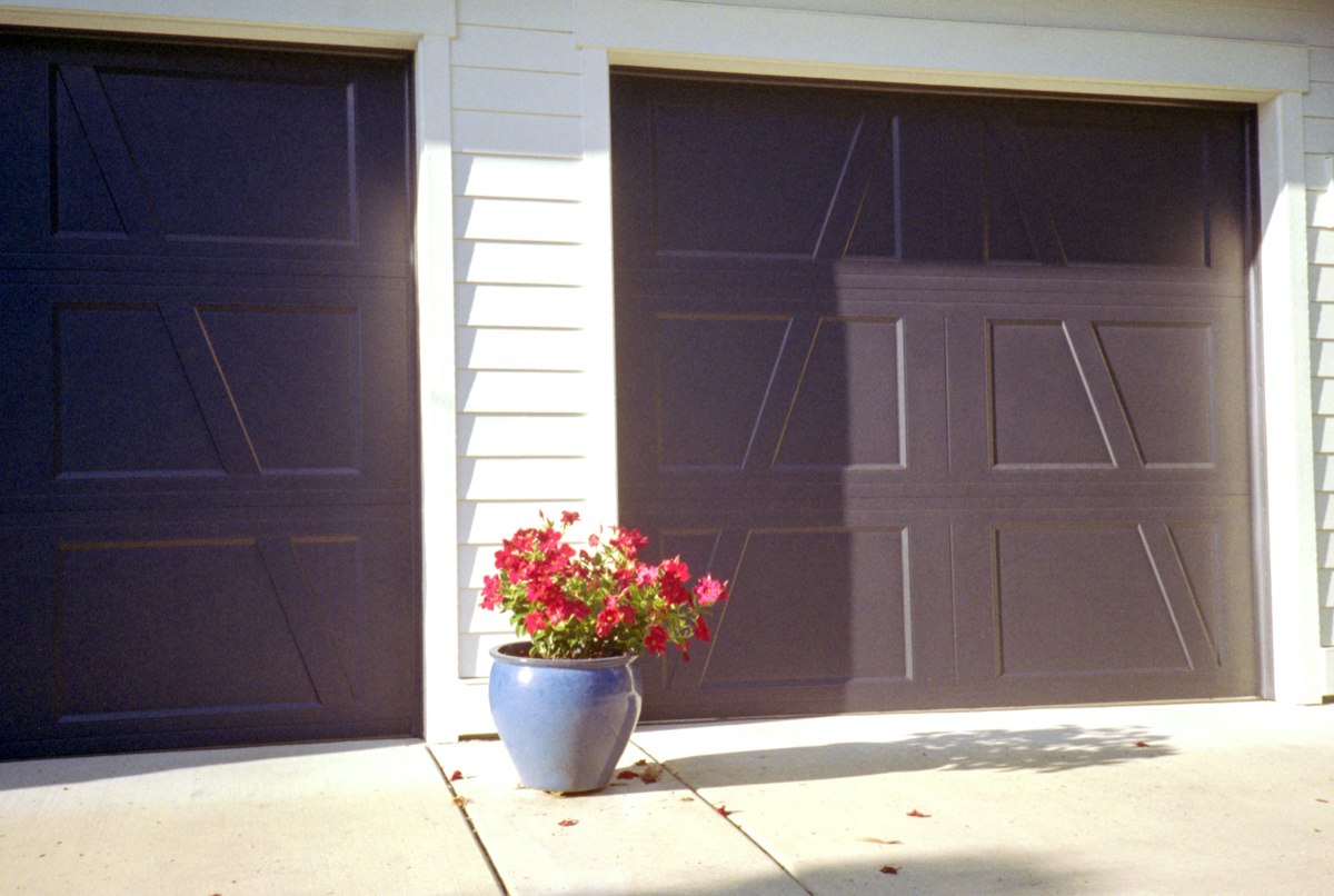Paneled residential garage doors seen from the driveway