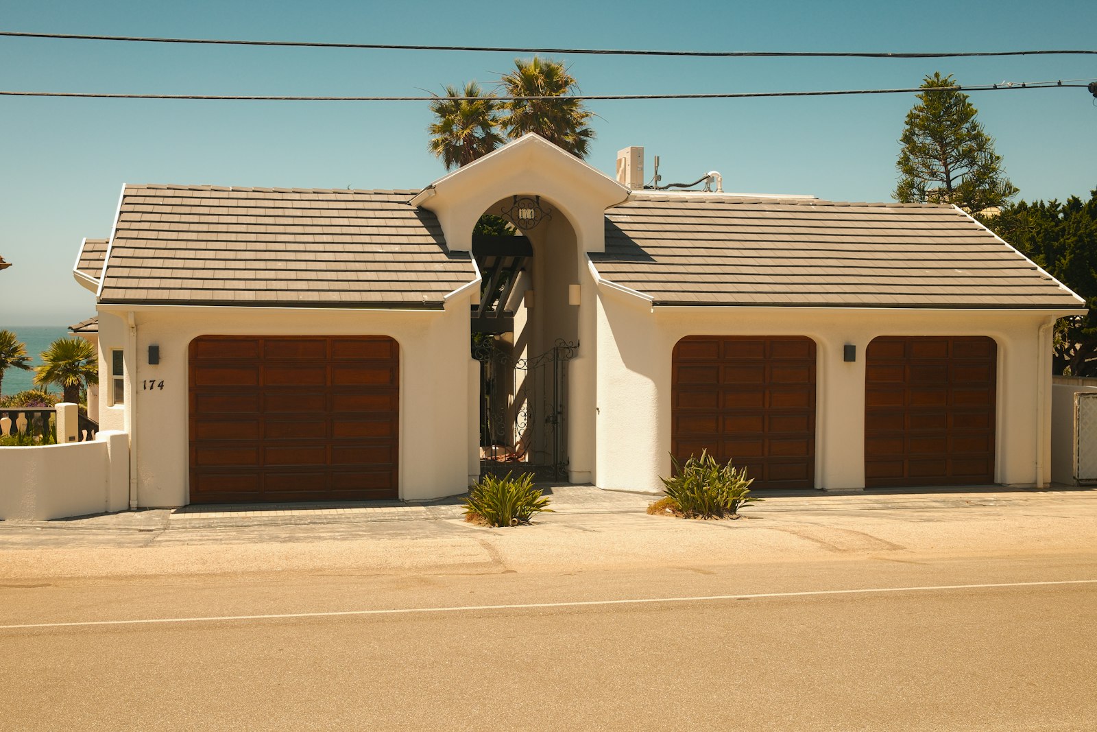 Three-bay garage with wooden doors
